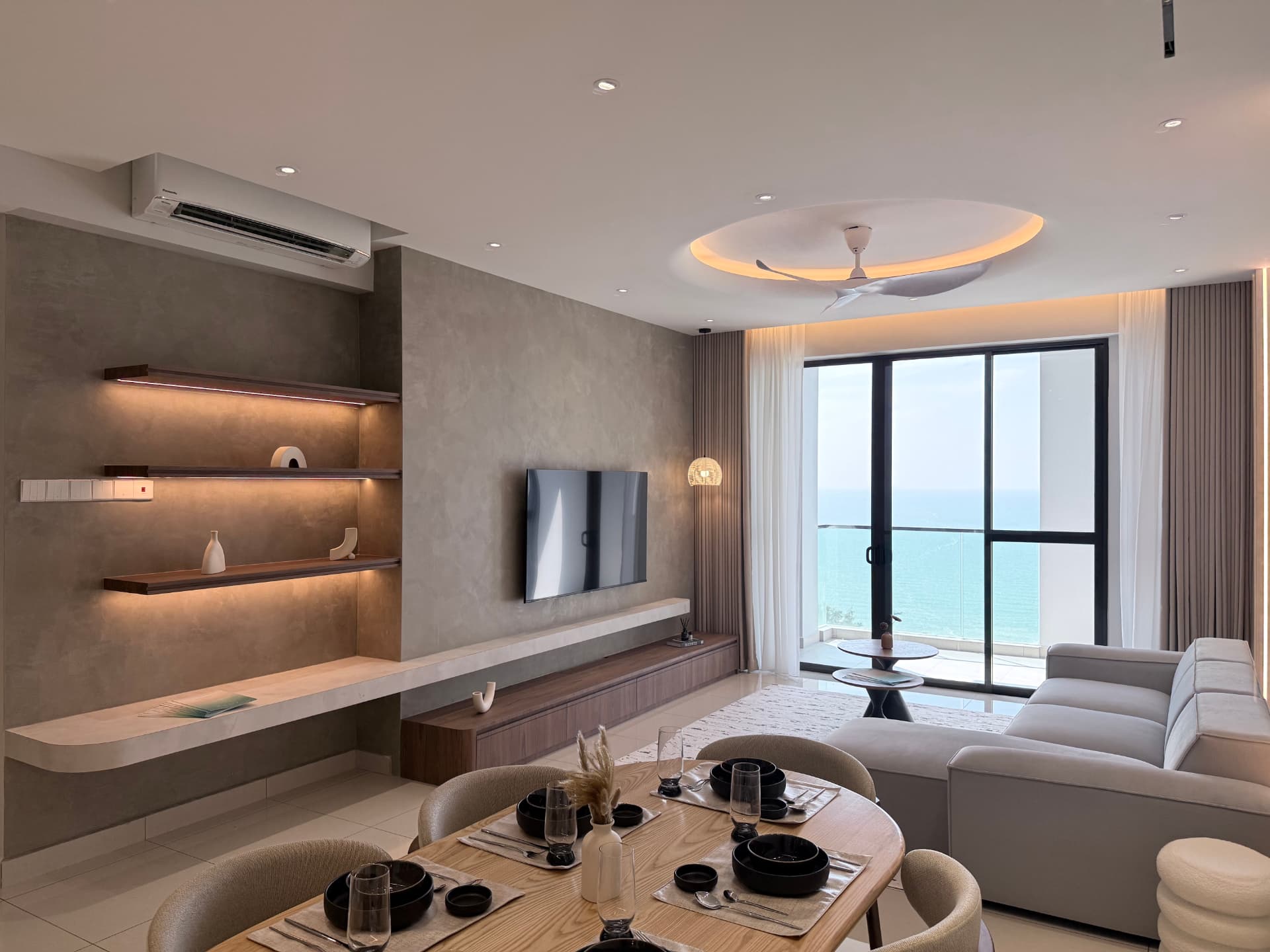 The Marin showroom living room with feature TV wall and sea view